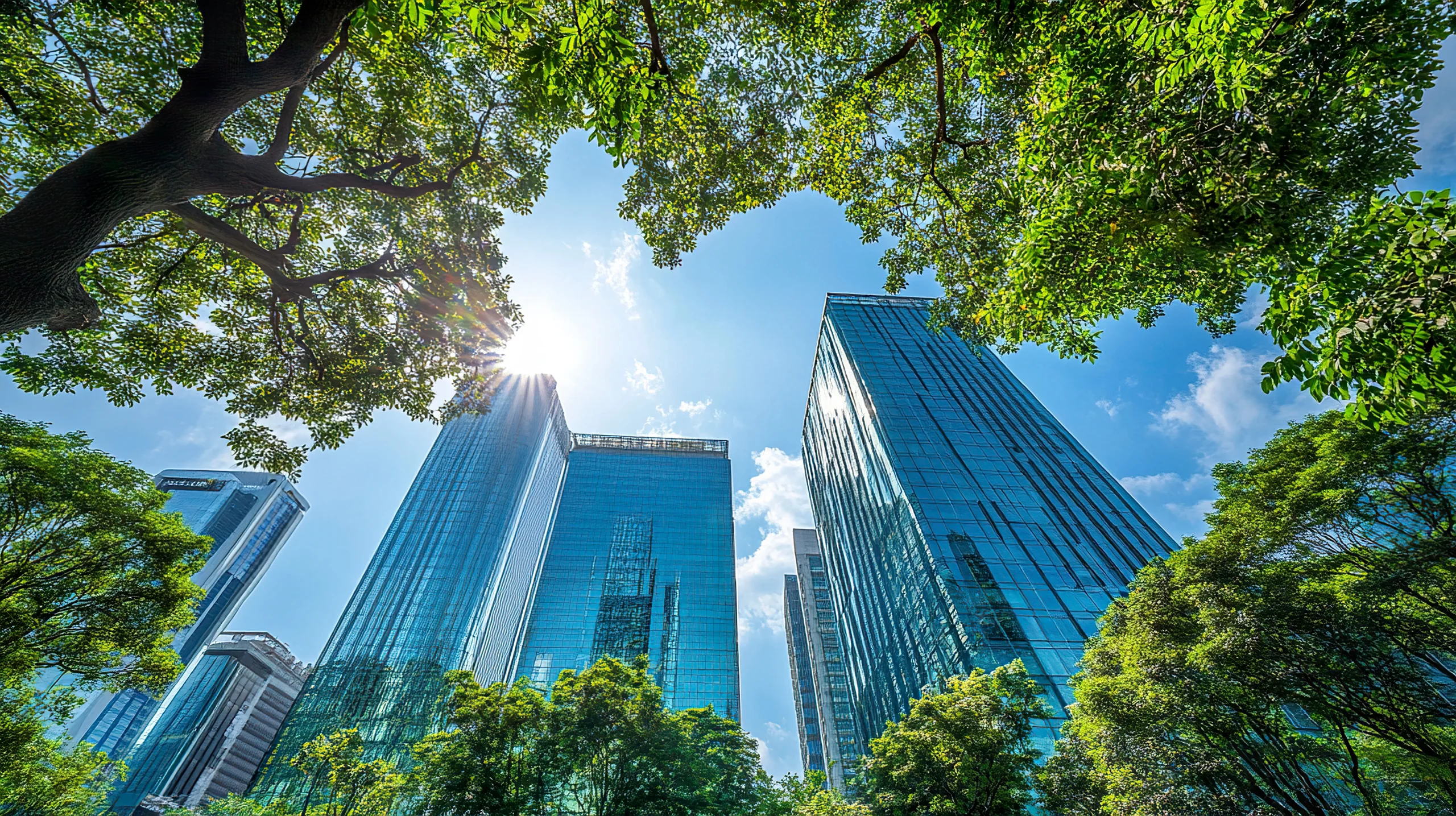 Modern office buildings surrounded by green trees, representing ISO 14001 environmental management systems, proactive environmental risk management, sustainability integration, and regulatory compliance in business operations.